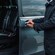 A private driver opening the door of a luxury mini van